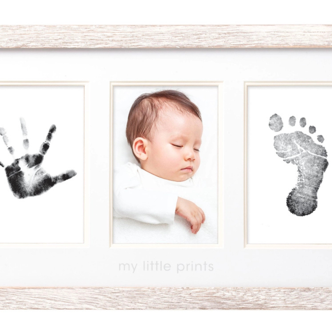 Rustic wood frame displaying two newborn photos alongside a perfectly captured baby handprint.