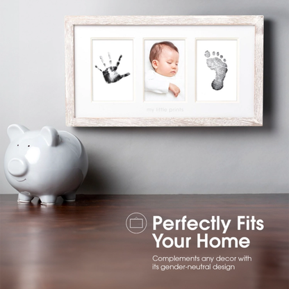 Rustic wood frame displaying two newborn photos alongside a perfectly captured baby handprint.