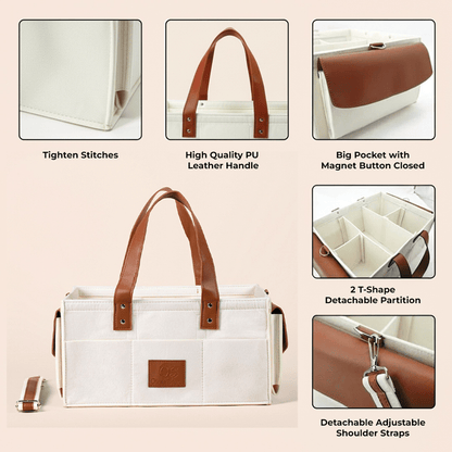 Cream tote bag with brown leather handles and compartments on a beige background