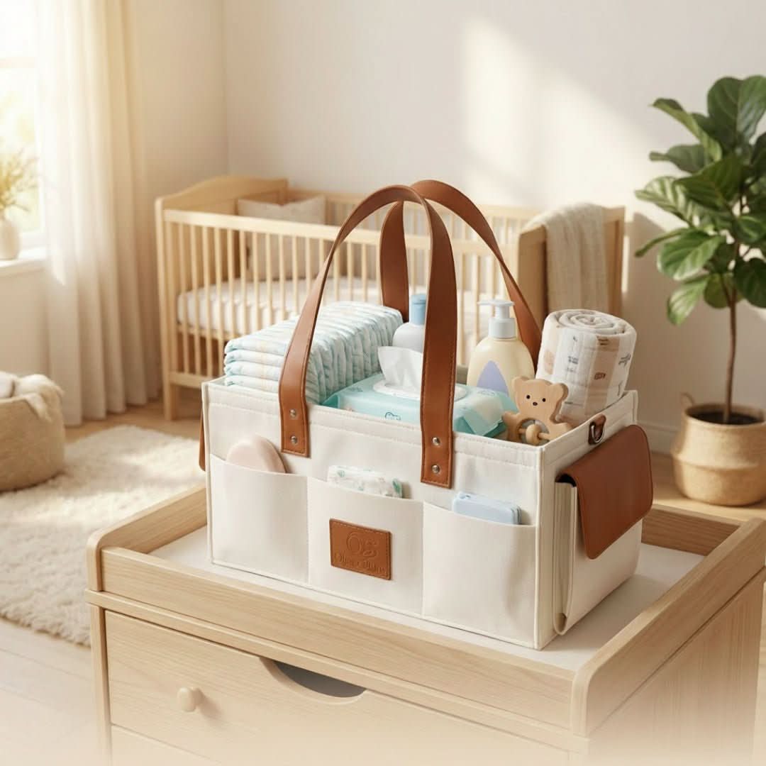 Cream diaper bag with brown leather straps filled with baby items in a nursery.